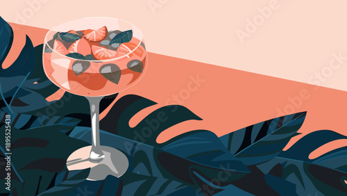 Tropical cocktail served in an elegant glass, decorated with fruit and leaves.