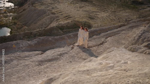 Wallpaper Mural Two girls walking through a rocky landscape. Concept of a journey through the rocks. Torontodigital.ca