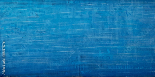 Blue chalkboard background with uneven surface depth and erased chalk texture