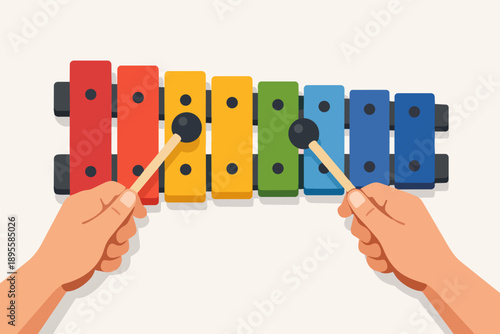 Hands playing a vibrant rainbow-colored xylophone, creating music and learning rhythm