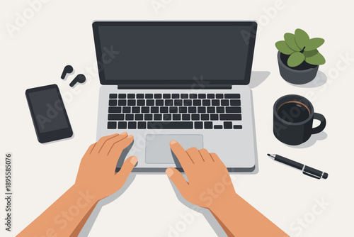 Person working on laptop computer, hands typing, using touchpad on office desk