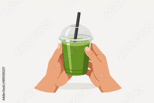 Hands holding green healthy smoothie drink in a plastic cup with a straw