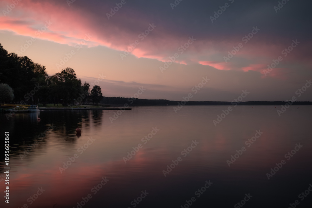 Obraz premium Serenity landscape panorama. Evening lake with dramatic sky and sunset