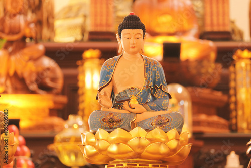 Buddha statue meditating in serene atmosphere of a dimly lit Buddhist temple interior, close up detailed shot. soft focus