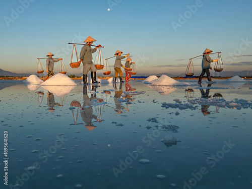 Images of people making salt manually in Ninh Diem early in the morning.