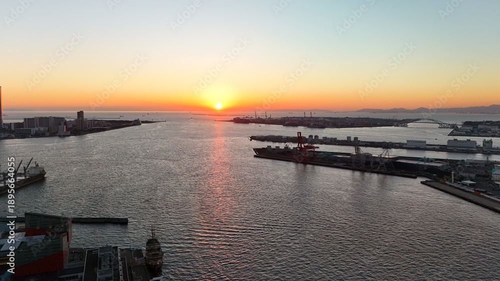 Fototapeta premium Osaka, Japan at sunset: Aerial Drone View of Tempozan Bridge, Tempozan Wharf, Harbour, Port of Osaka, Harbour, Osaka Bay, Ferris Wheel, City Skyline, Evening Colours in Konohana and Minato Ward