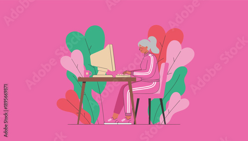 Active senior woman in a pink tracksuit typing on a desktop computer symbolizing digital connectivity