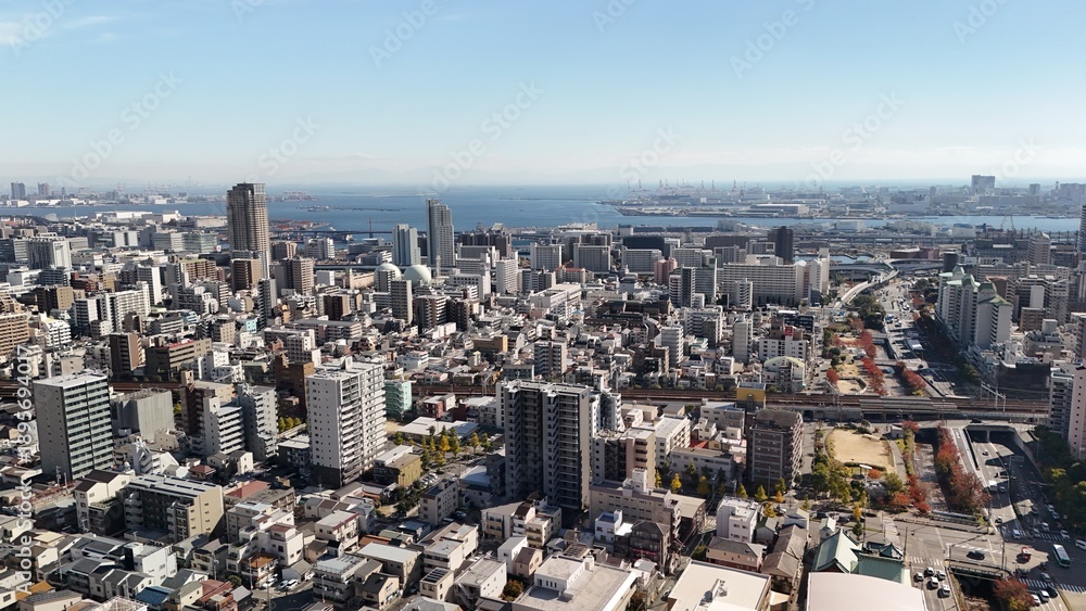 Obraz premium Kobe city, Hyogo Prefecture, Japan in Autumn – Aerial Drone view of Ikutagawa River, Cherry Tree Avenue, Canal, City Skyline in Chuo Ward, Urban Streets and Rokko Mountain Range, Ocean Views