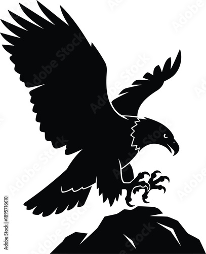 Majestic bird of prey landing on mountain peak silhouette