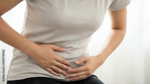 Wallpaper Mural Woman holding her stomach in pain, abdominal discomfort and health issue concept. Torontodigital.ca