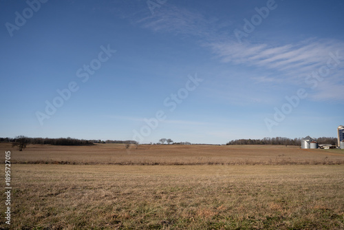 Wide open farmland in the countryside under a blue sky