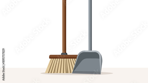 Broom and dustpan standing together on a clean floor, viewed from the side, in an empty space