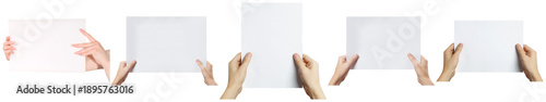 diverse photograph of various human hands holding up blank white rectangular sheets of paper, ideal for customizable text.