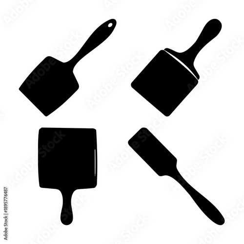 A collection of diverse black silhouette kitchen spatulas and turners on a white background