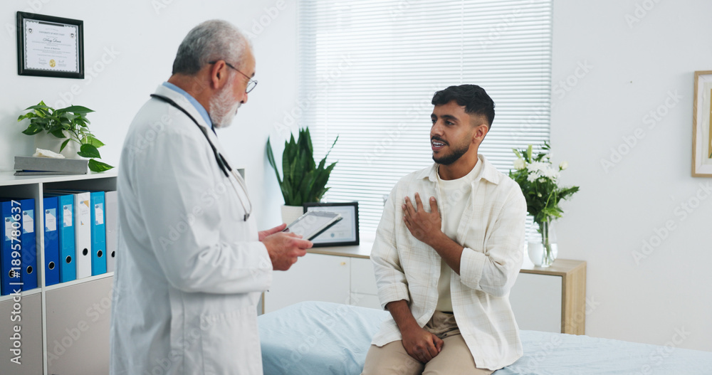 Obraz premium Doctor, chest pain and consultation with tablet, healthcare symptoms or heart assessment in clinic. Sick man, medical worker and patient with breathing problem, lung checkup or cardiology with tech