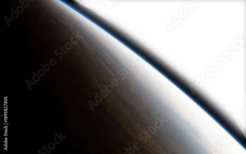 Expansive view of a celestial body's atmosphere curving into the blackness of space illuminated by a brilliant light source creating a dramatic gradient from shadow to bright