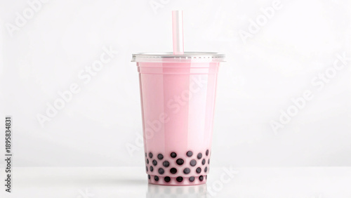 A refreshing cup of pink strawberry milk bubble tea with black tapioca pearls and a straw on a white background.