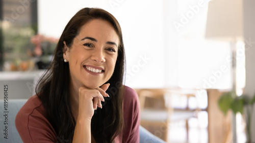Photos Close up portrait of cheerful middle-aged 40s brunette woman sits alone on cozy