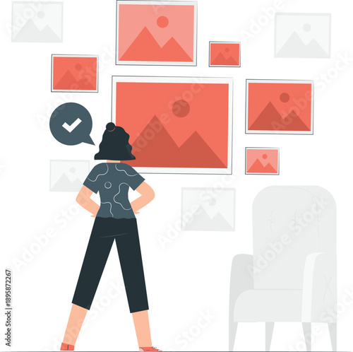 Woman examining various graphic illustrations and photos on the wall in a modern interior space from behind viewpoint