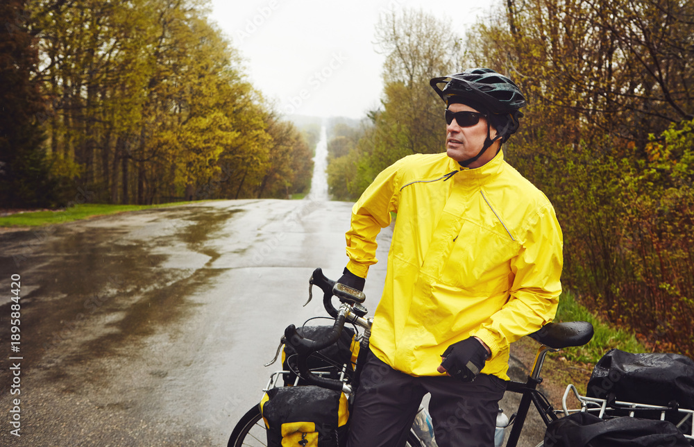 Naklejka premium Travel, man and break with touring bicycle in nature for exploring, bikepacking and winter adventure. Cyclist, mature person and relax with bike on wet road for sightseeing, cycling rest and freedom
