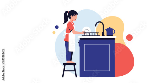 Young girl wearing an apron and standing on a stool to wash a white plate at a kitchen counter with a blue cabinet.