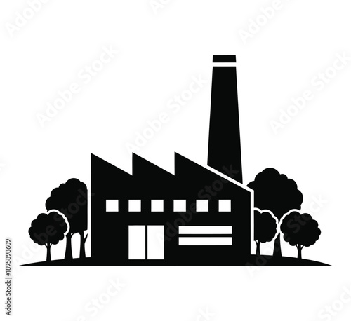 Industrial factory building with trees and chimney