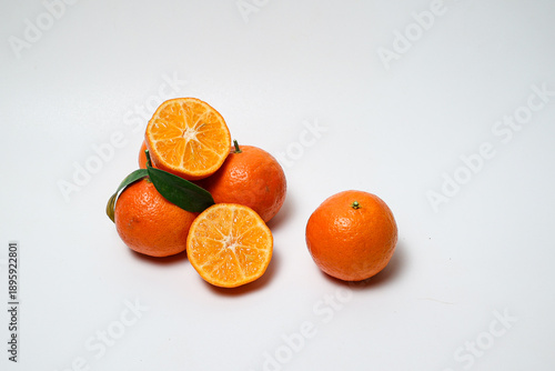 Fresh orange fruit with slices on isolated white background.