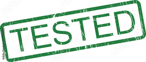 A prominent green rubber stamp mark showing the word TESTED with a noticeable, slightly gritty texture