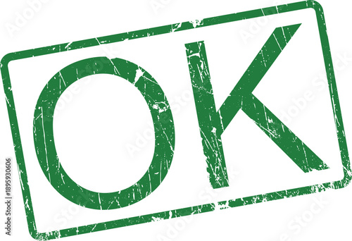 Green rubber stamp with an aged appearance displaying the simple word OK within a rectangular boundary on white