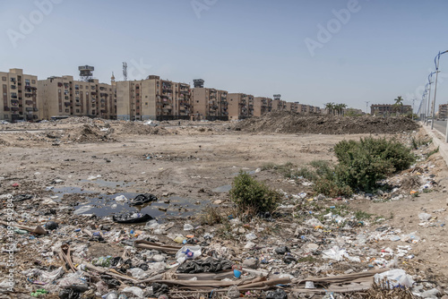 Valokuva Pollution and litter cover urban lot amid Port Said apartment buildings, highlighting Egypt waste management issues