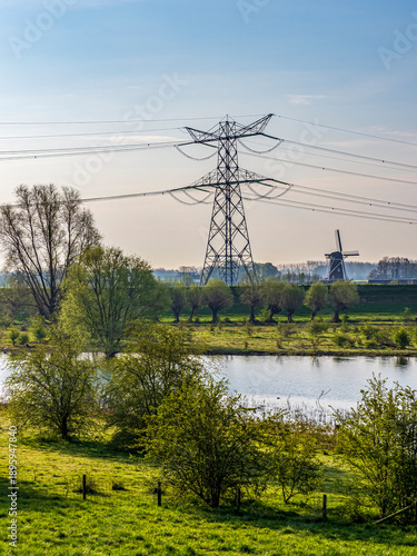 Power lines and windmill in Dutch polder landscape