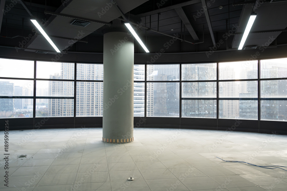 Naklejka premium Empty office building interior with floor-to-ceiling windows