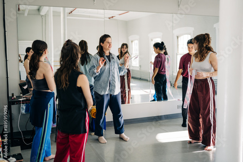 Dance instructor teaching choreography to students in studio