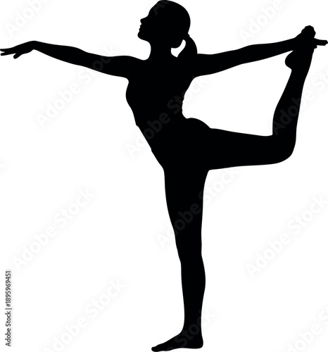 Woman in a yoga pose standing on one leg with arms outstretched