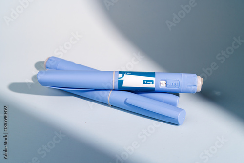 High quality shot of semaglutide GLP-1 pens for weight loss and blood sugar management on a soft blue gradient background for science.