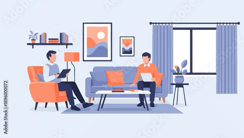 Two men working on laptops in a living room with art