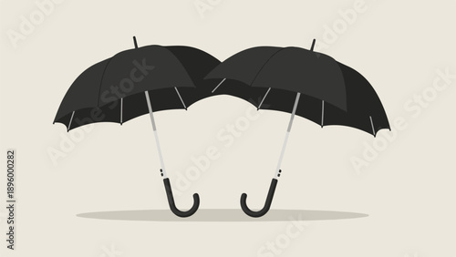Two black umbrellas angled towards each other against a neutral background