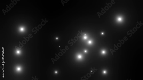 黒背景にゆっくり浮かび上がる白い粒子