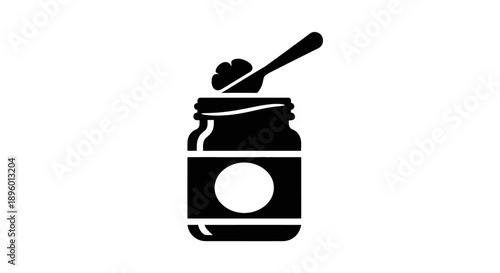 A jar filled with a substance and a spoon on top viewed from the front