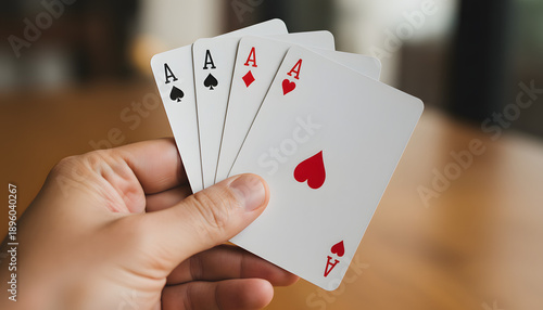 Close-up of a Hand Holding Four Aces Playing Cards