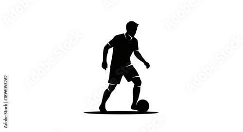 Silhouette of a soccer player dribbling a ball.