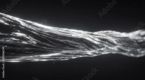 Dynamic silver wave flowing across a dark background from a close-up viewpoint showcasing abstract fluid motion