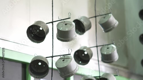 Industrial metal parts suspended for pre-painting treatment in a factory workshop