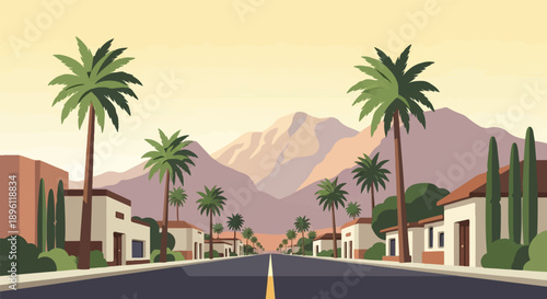 Desert town street lined with palm trees and mountains beyond