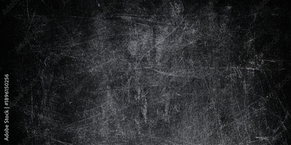 Fototapeta premium Vintage black grunge background with heavy white scratches a distressed chalkboard or worn metal look, perfect for creators looking to add grit.