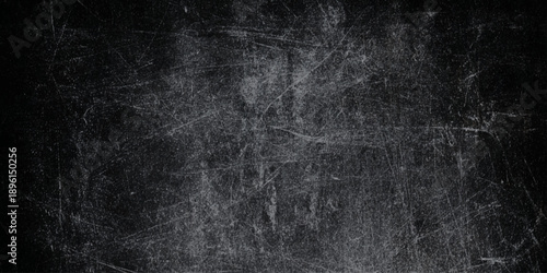 Vintage black grunge background with heavy white scratches a distressed chalkboard or worn metal look, perfect for creators looking to add grit.