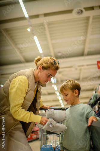 Wallpaper Mural Modern mother shopping with her young son in a large grocery supermarket aisle, choosing fresh food together. Family lifestyle, parenting, everyday routine, healthy choices concept. Torontodigital.ca