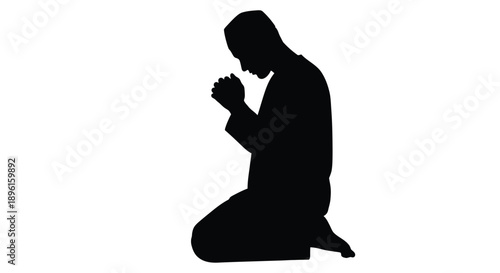 Silhouette of a man kneeling in prayer facing downwards