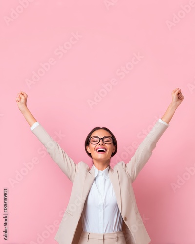 Celebration of success young professional in business attire pink background emotional expression joyful moment