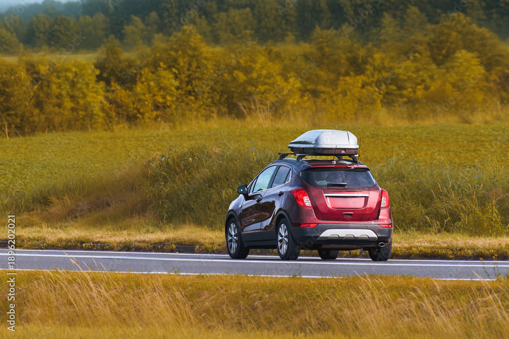 Fototapeta premium Compact European crossover SUV on countryside road